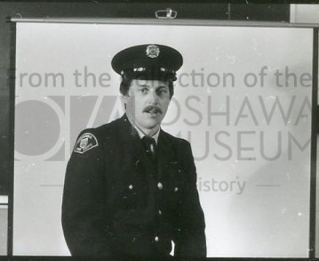 Black and white photo of a Caucasian man, with a moustache, wearing an Oshawa Fire Department uniform
