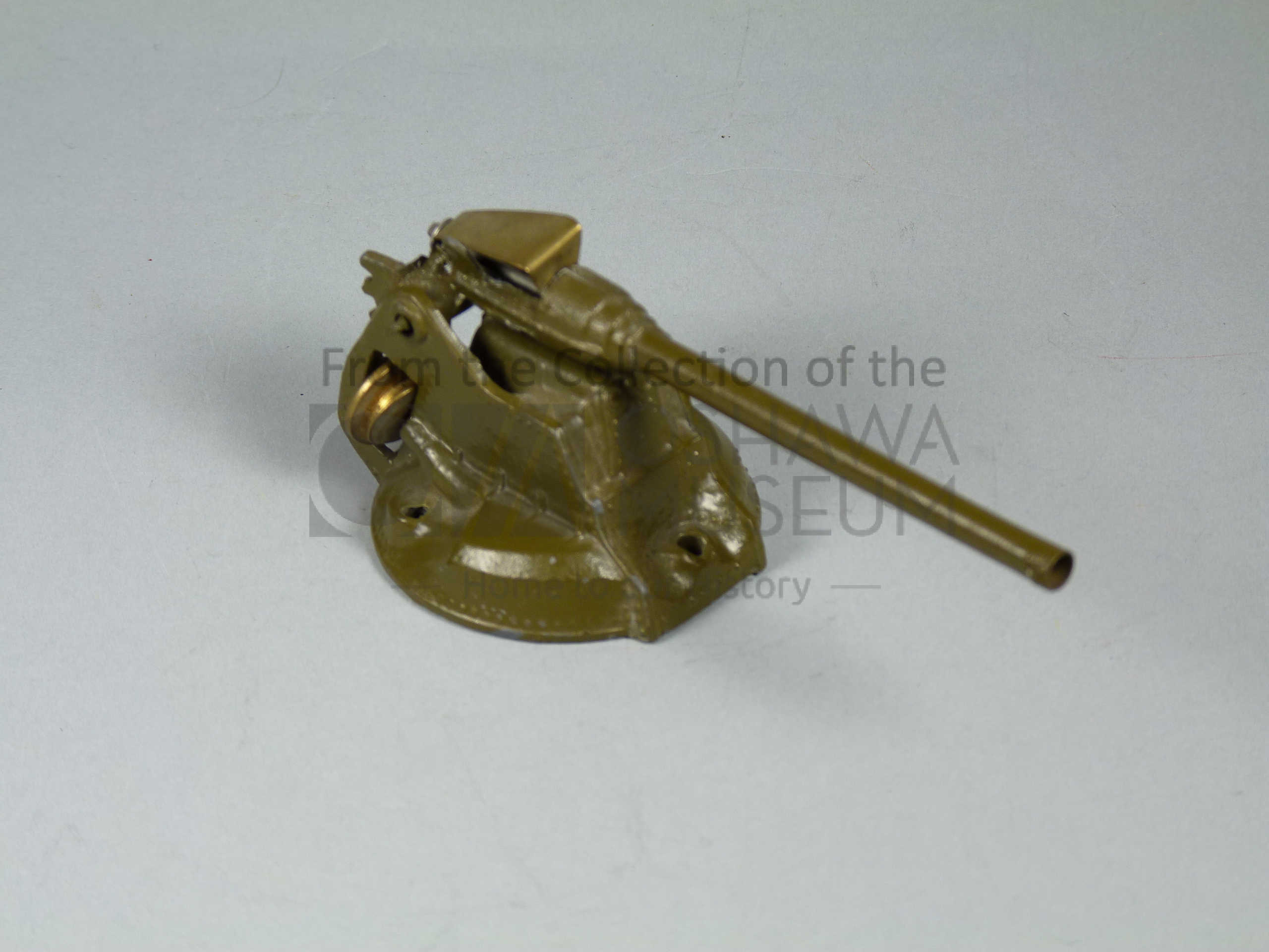 Small, khaki coloured metal toy canon.