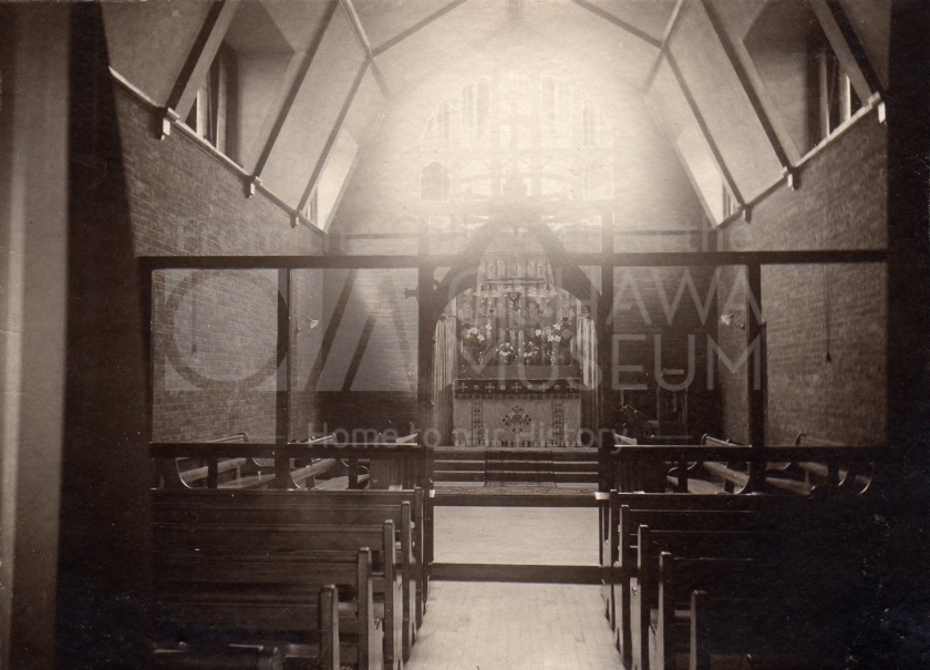Sepia photo of a room with pews and an alter